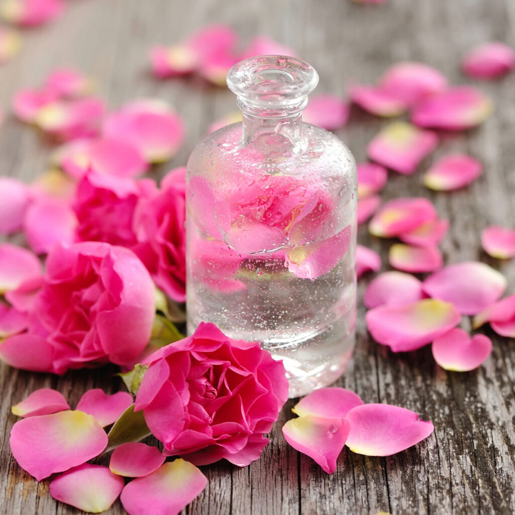 A bottle of water with pink flowers on it
