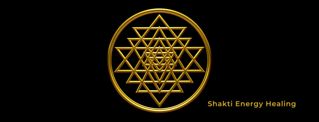 A gold colored symbol of the sri yantra.